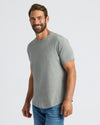 Man wearing Heather Gray Curved Hem Classic Crew Neck and blue jeans.