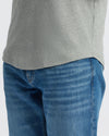 Heather Gray Curved Hem Classic Crew Neck on a person, tucked into jeans.