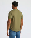 Man wearing Military Green Curved Hem Classic Crew Neck and blue jeans.