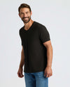 Man wearing All Black Classic V-Neck T-Shirt, smiling confidently.