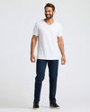 Man wearing All White Classic V-Neck 10-Pack, dark jeans, black sneakers.