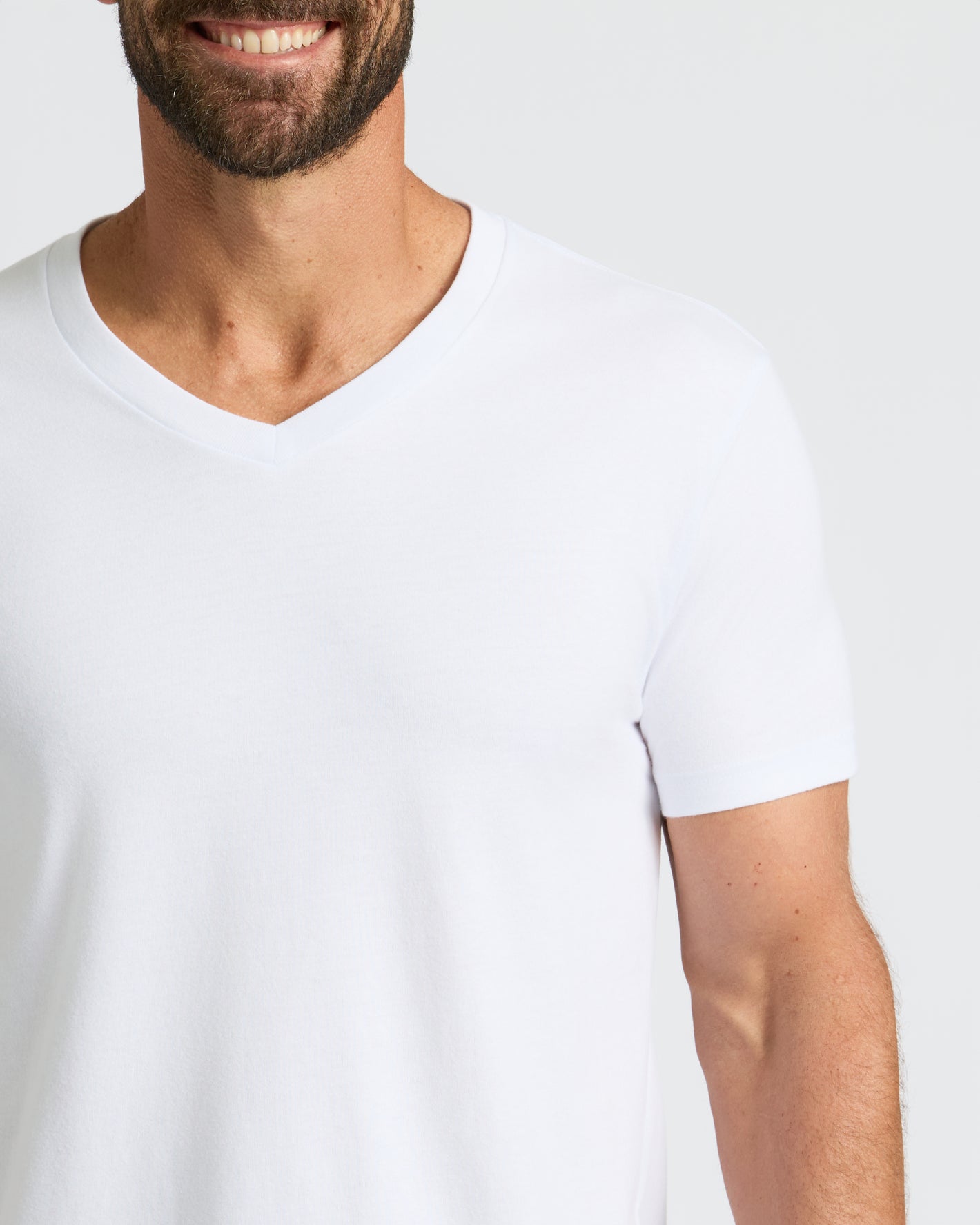 Smiling man wearing All White Classic V-Neck 10-Pack shirt.