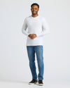 Man wearing White Classic Long Sleeve Crew Neck, medium-wash jeans, sneakers.