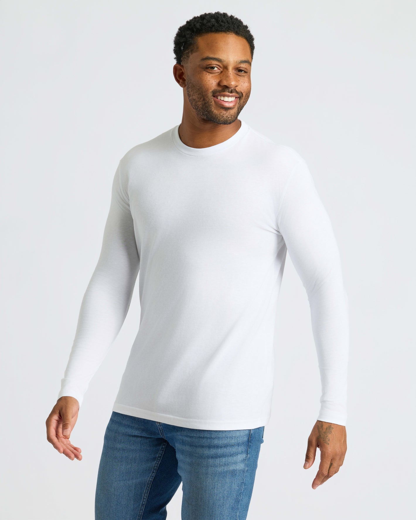 White Classic Long Sleeve Crew Neck 10-Pack worn by smiling Black man.
