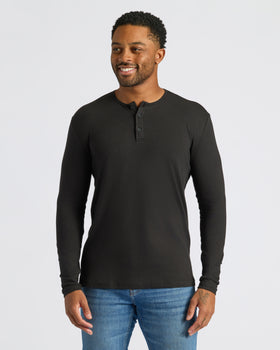 Man in Black Long Sleeve Henley with medium-wash jeans.