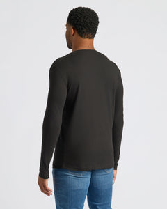 True ClassicPerson wearing All Black Classic Henley, seen from behind, with short curly hair.