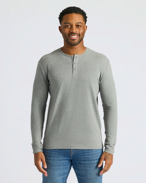 Man wearing Heather Gray Classic Long Sleeve Henley and blue jeans.