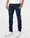 Wearing Staple Slim Comfort Knit Chino Pant in navy with white sneakers.