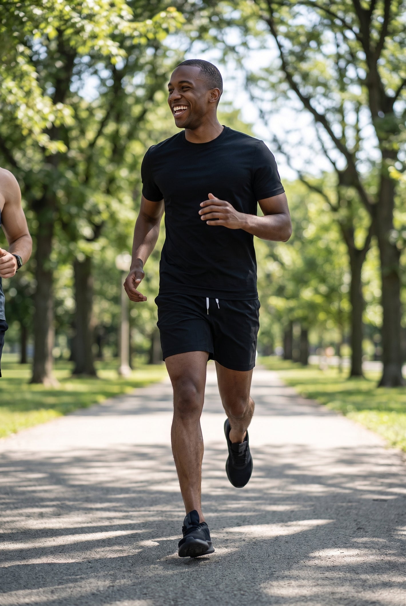 Man running outdoors in a black crew neck shirt and shorts, showcasing men's basics from Midnight Motion - Active Crew, Shorts, & Boxers