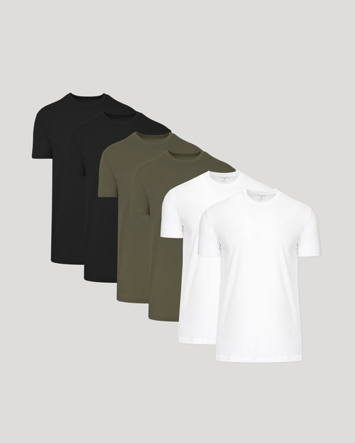 6 short-sleeve crew-neck t-shirts in black, dark olive green, and white, arranged in a staggered fan layout against a solid light gray background.