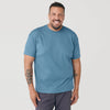 Man wearing Bluestone Short Sleeve Crew Neck Tee, smiling, tattooed forearms.