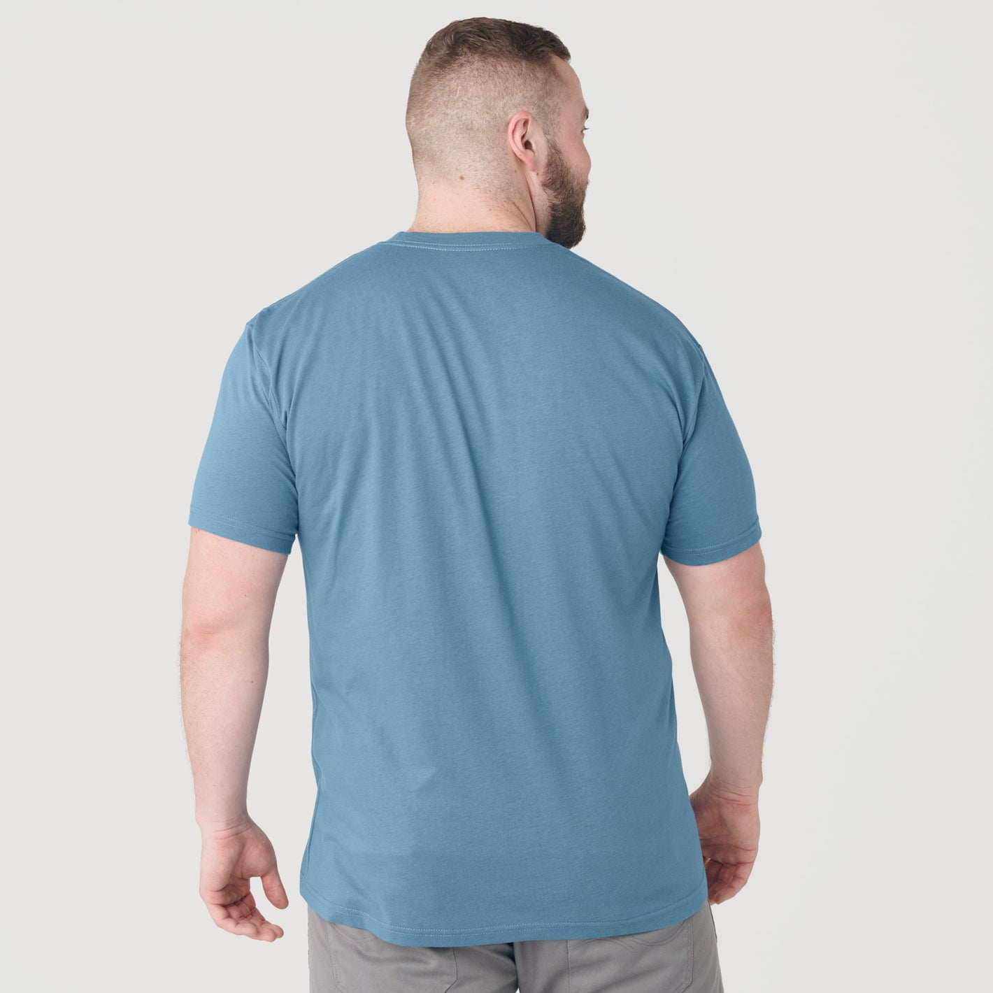 Man in Bluestone Short Sleeve Crew Neck Tee, rear view.