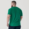 Man wearing Kelly Green Short Sleeve Crew Neck Tee and dark jeans.