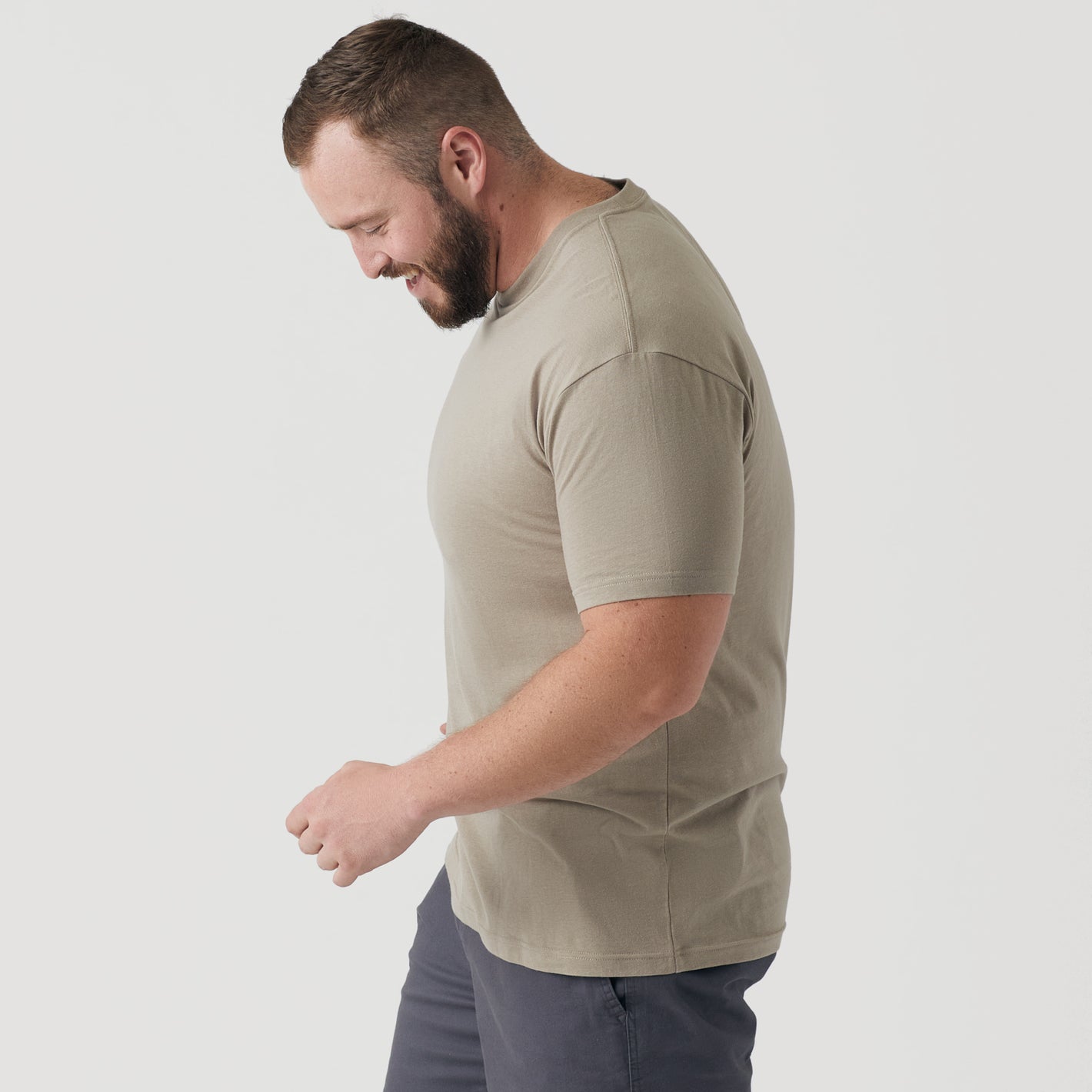 Man wearing Military Beige Short Sleeve Crew Neck Tee, smiling in profile.
