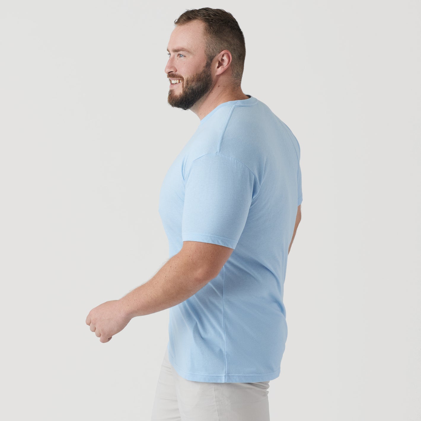 Man wearing Oxford Blue Short Sleeve Crew Neck Tee in profile view.