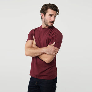 True ClassicMan wearing Burgundy Short Sleeve Crew Neck Tee with dark jeans, arms crossed.