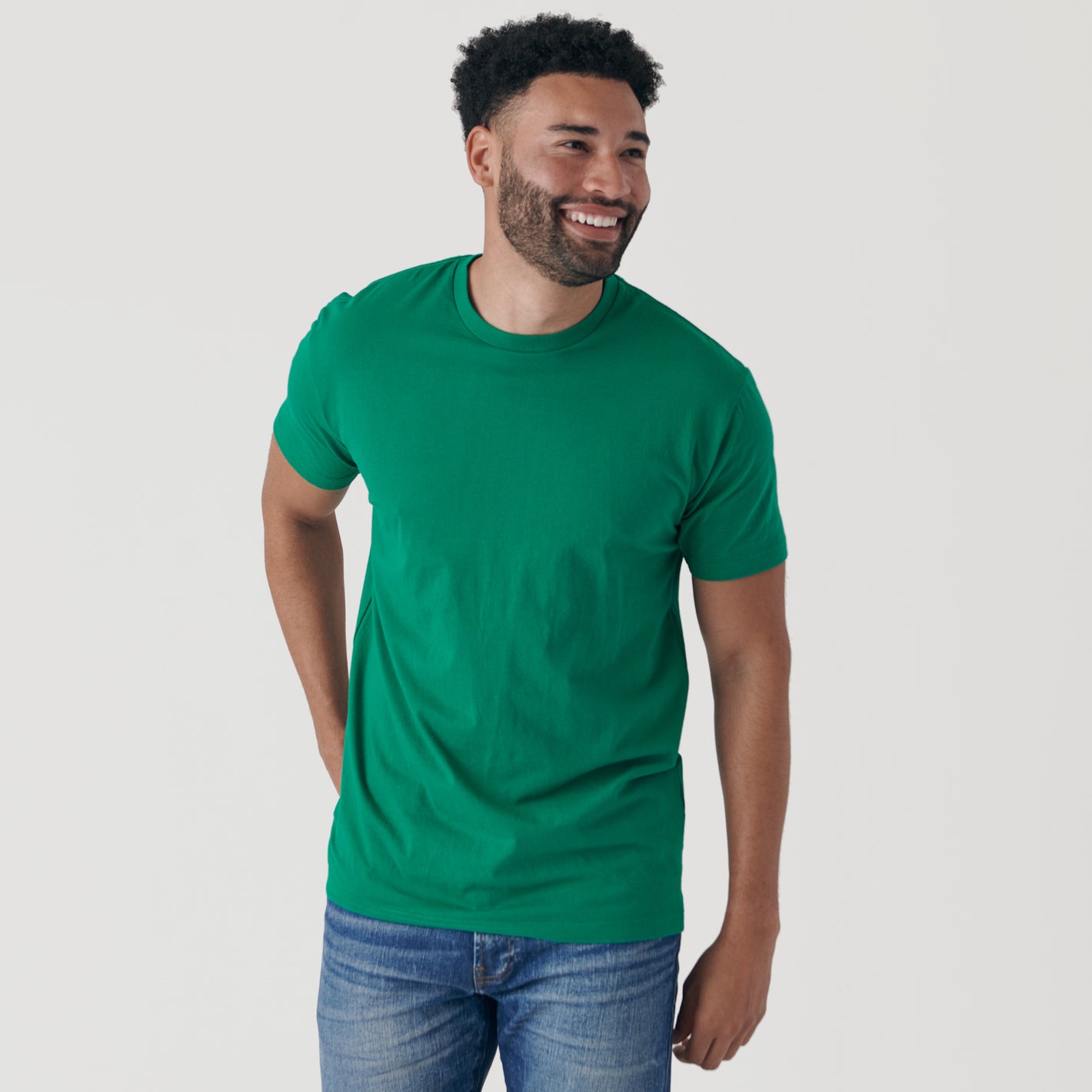 Smiling man wearing Kelly Green Short Sleeve Crew Neck Tee.