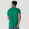 Man wearing Kelly Green Short Sleeve Crew Neck Tee and blue jeans.