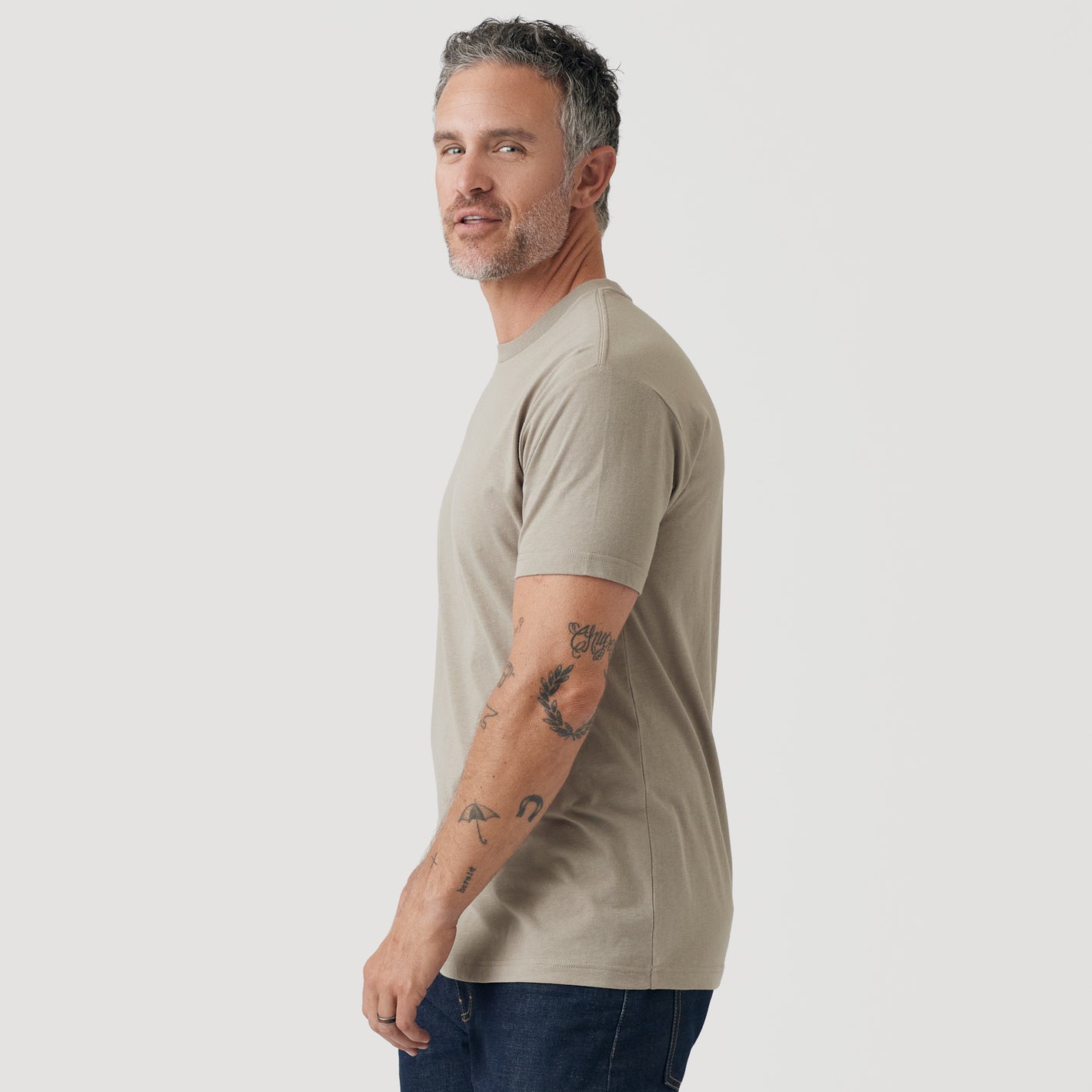Man wearing Military Beige Short Sleeve Crew Neck Tee with tattoos visible.