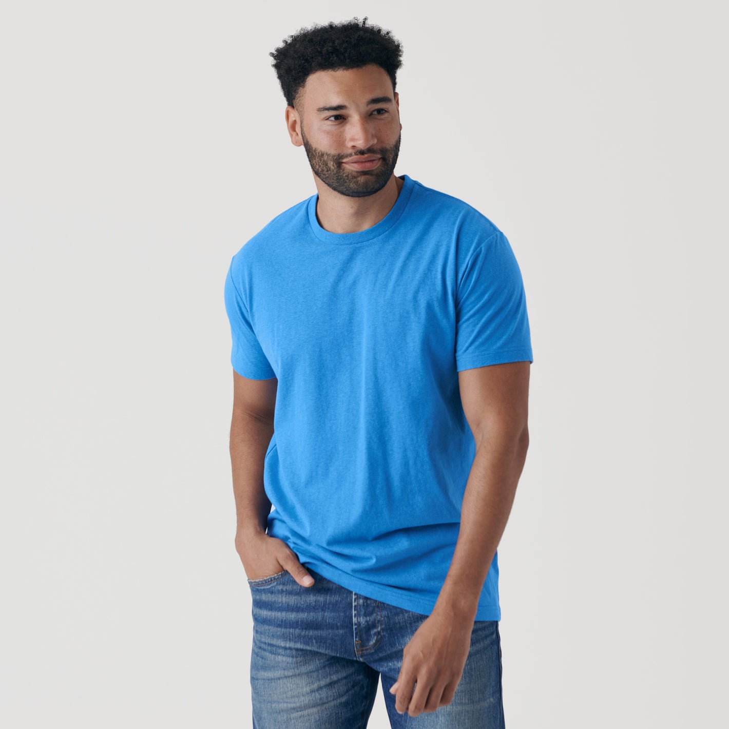 Man wearing Periwinkle Blue Short Sleeve Crew Neck Tee and jeans.