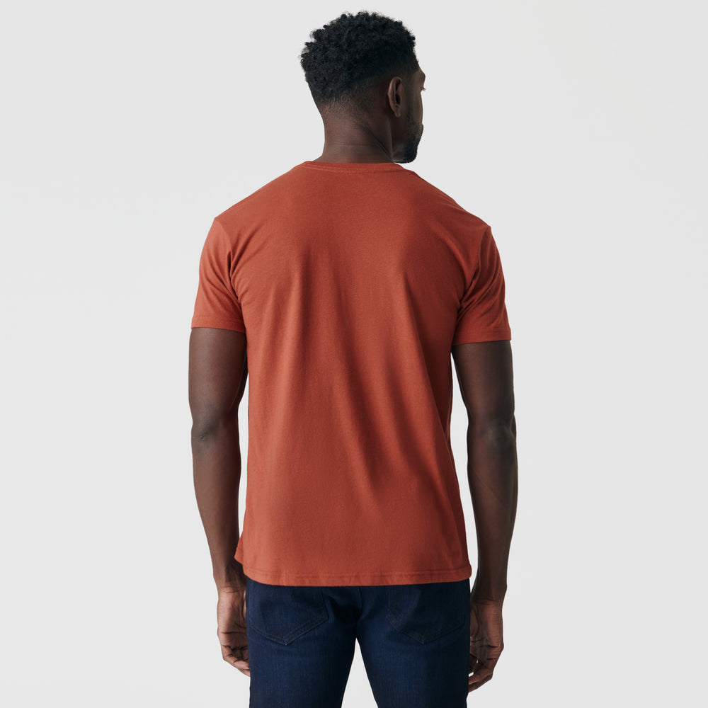 Person wearing Rust Short Sleeve Crew Neck Tee and dark jeans.