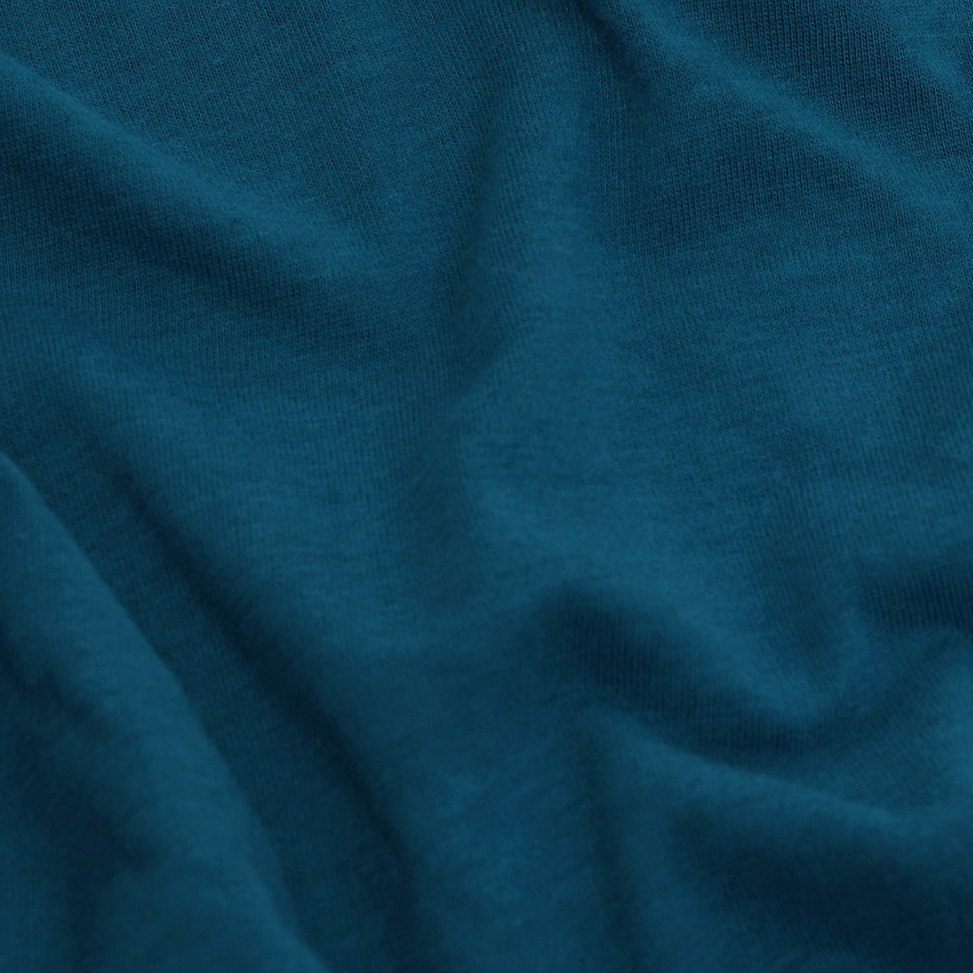Teal Short Sleeve Crew Neck Tee with soft fabric folds.