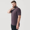 Man in Heather Purple Short Sleeve Polo, relaxed pose, hand on neck.