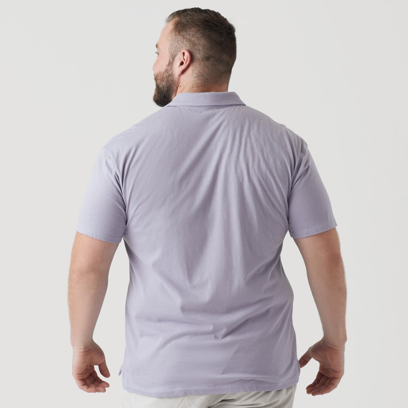 Man wearing Lilac Gray Short Sleeve Polo, back view.