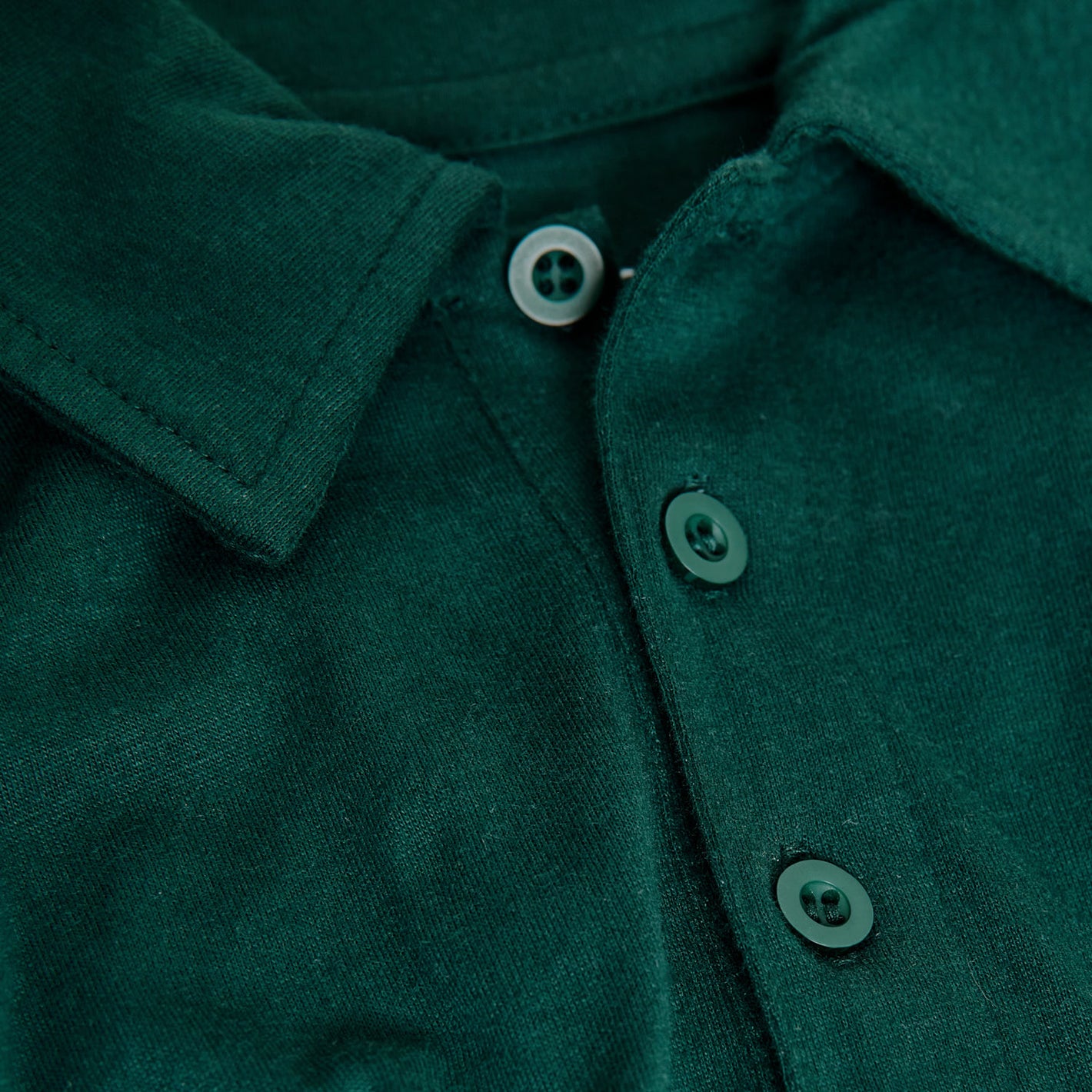 Emerald Classic Polo close-up with green buttons and collar.