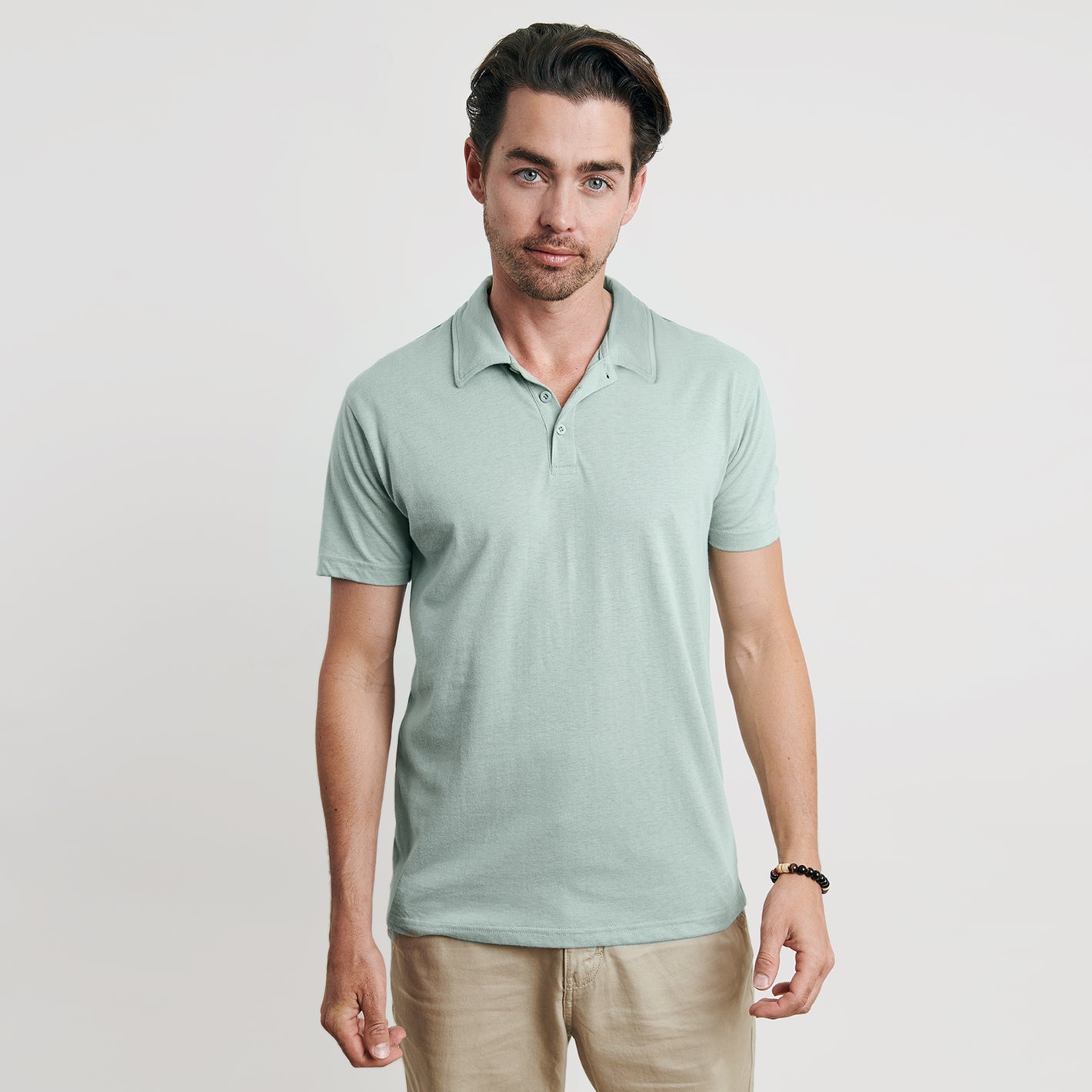 Man modeling Sage Short Sleeve Polo with khaki pants.