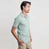 Man wearing Sage Short Sleeve Polo, looking right.