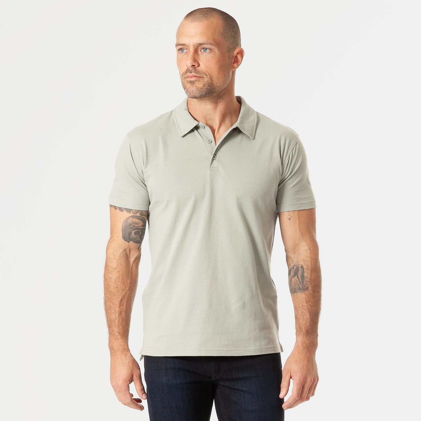 Man wearing Slate Green Short Sleeve Polo with dark blue jeans.