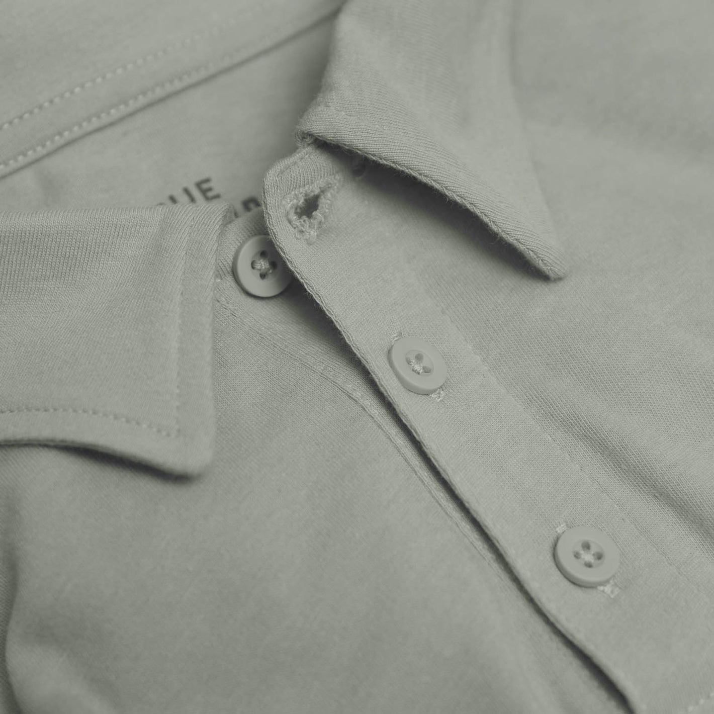 Slate Green Short Sleeve Polo with folded collar and button placket.
