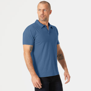 True ClassicMan wearing Stone Blue Short Sleeve Polo with dark trousers.