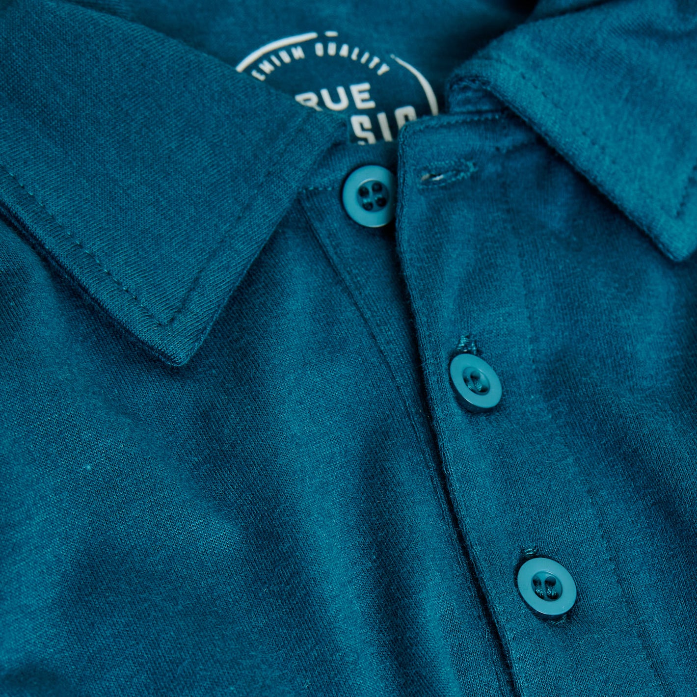 Teal Short Sleeve Polo with button-front and soft knit fabric.
