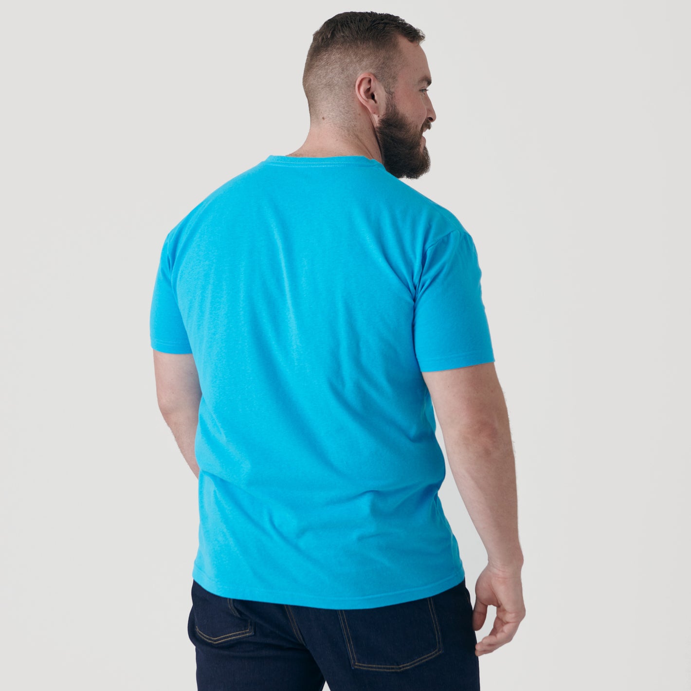 Man wearing Turquoise V-Neck Tee, photographed from behind.
