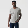 Man wearing Iron Gray Classic V-Neck and jeans, neutral expression.