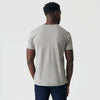Man wearing Iron Gray Classic V-Neck, dark jeans, slight profile view.
