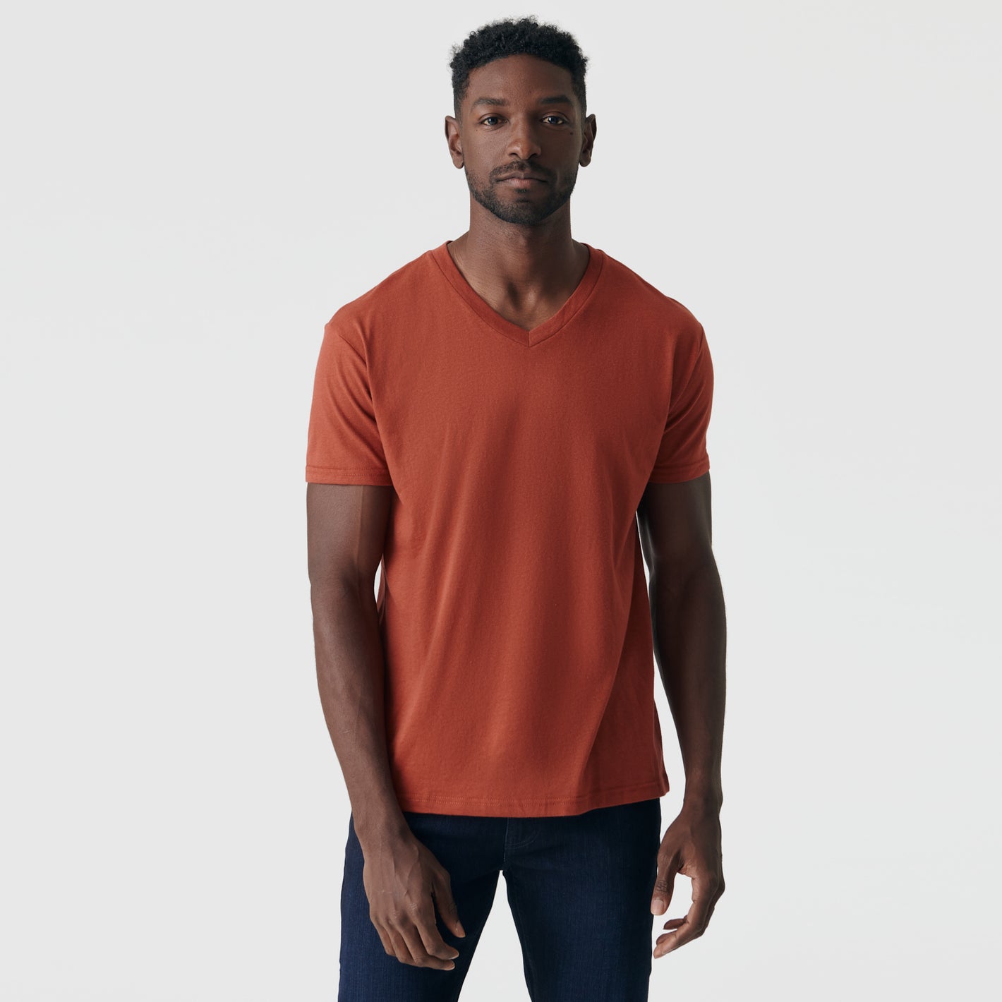 Rust V-Neck Tee on man with neutral expression.