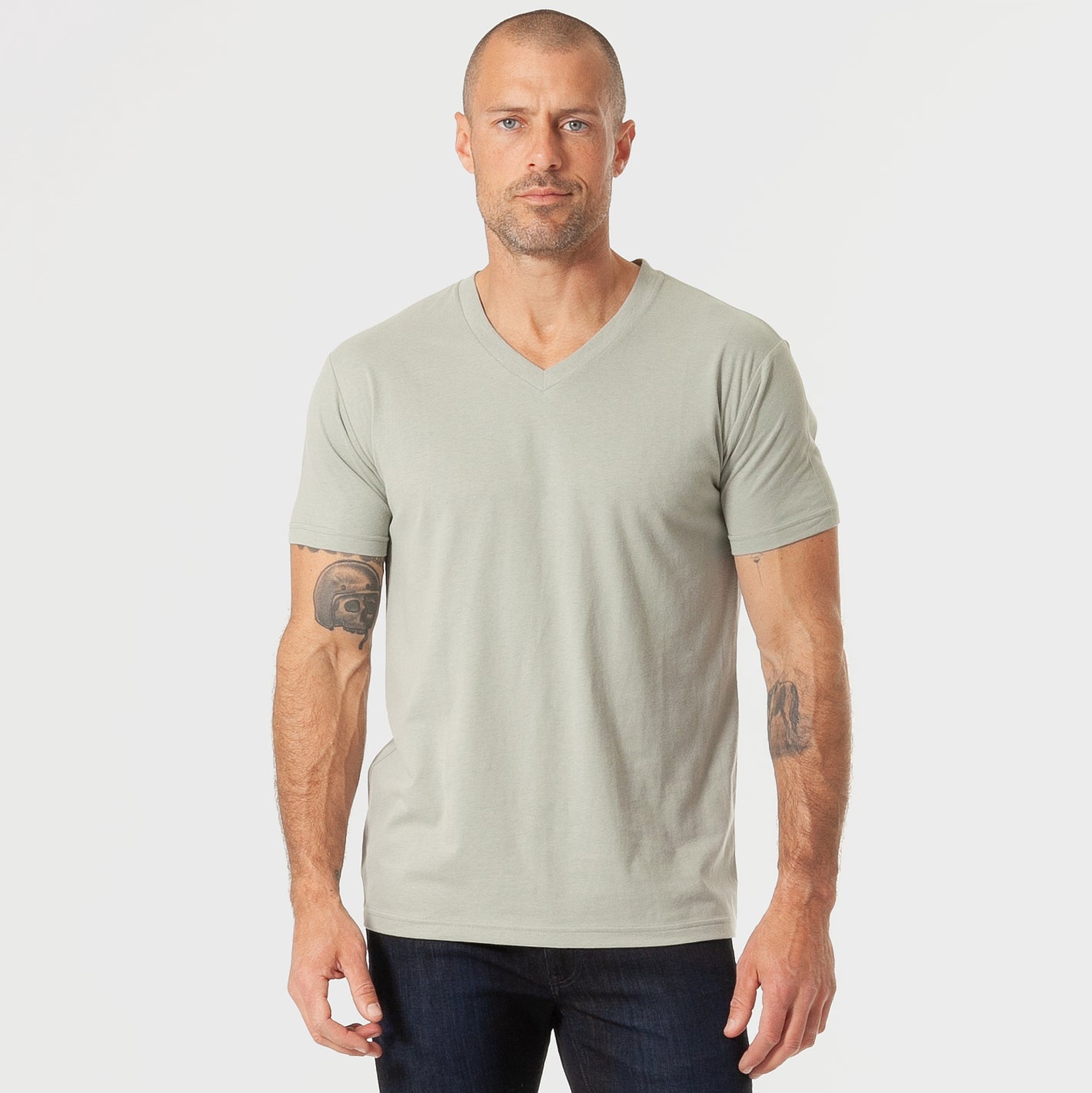 Man wearing Slate Green V-Neck Tee and dark jeans.