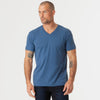 Man wearing Stone Blue V-Neck Tee and dark jeans.