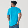 Man in Turquoise V-Neck Tee and jeans, back view.