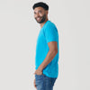 Turquoise V-Neck Tee on smiling man in jeans, side profile.