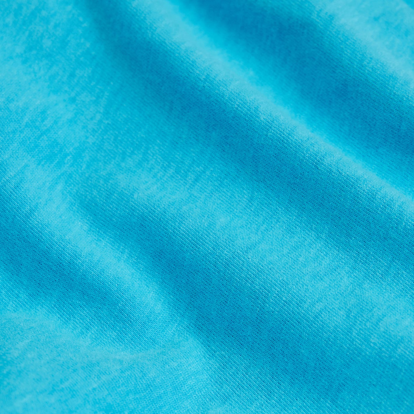Turquoise V-Neck Tee with soft knit texture and gentle folds.
