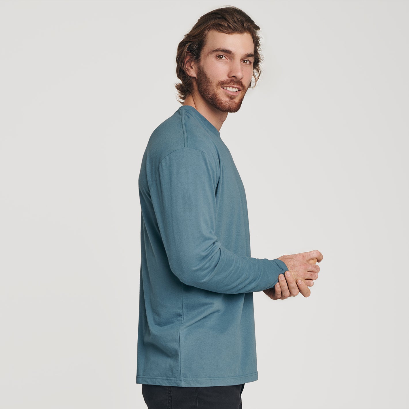 Man wearing Bluestone Long Sleeve Crew Neck Tee in profile.
