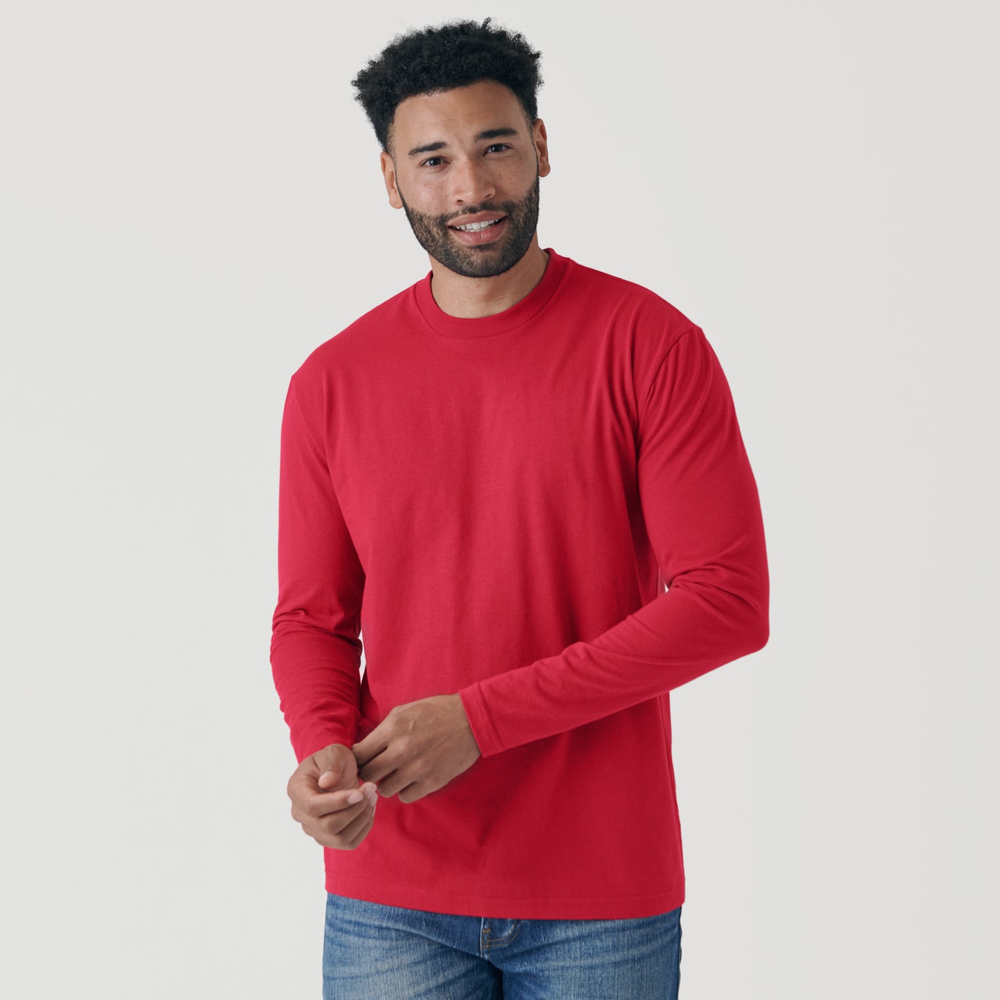 Man wearing Raspberry Classic Long Sleeve Crew Neck adjusting sleeve.