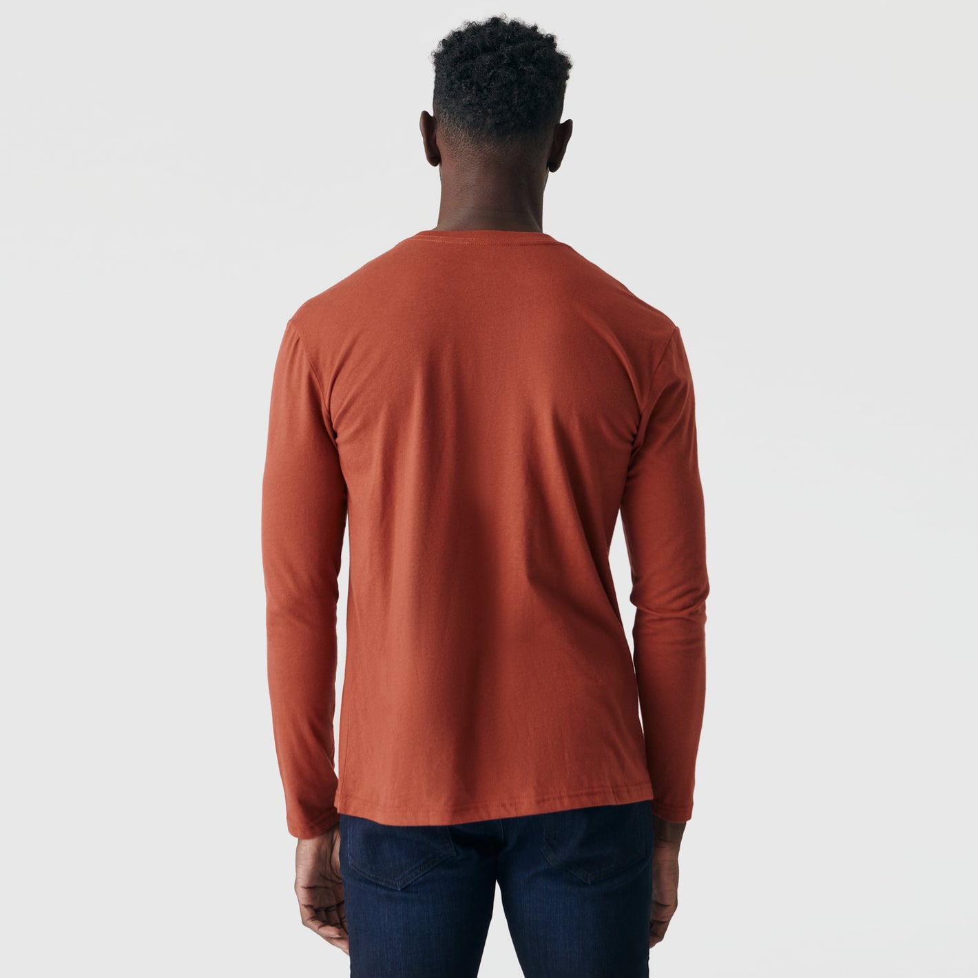 Rust Long Sleeve Crew Neck Tee worn by person facing away.