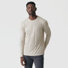 Man wearing Sandstone Long Sleeve Crew Neck Tee and dark jeans.