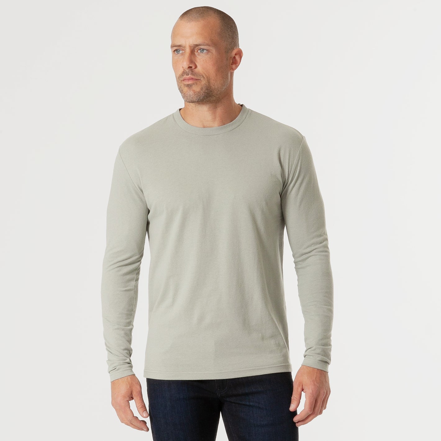 Man in Slate Green Long Sleeve Crew Neck Tee and dark jeans.