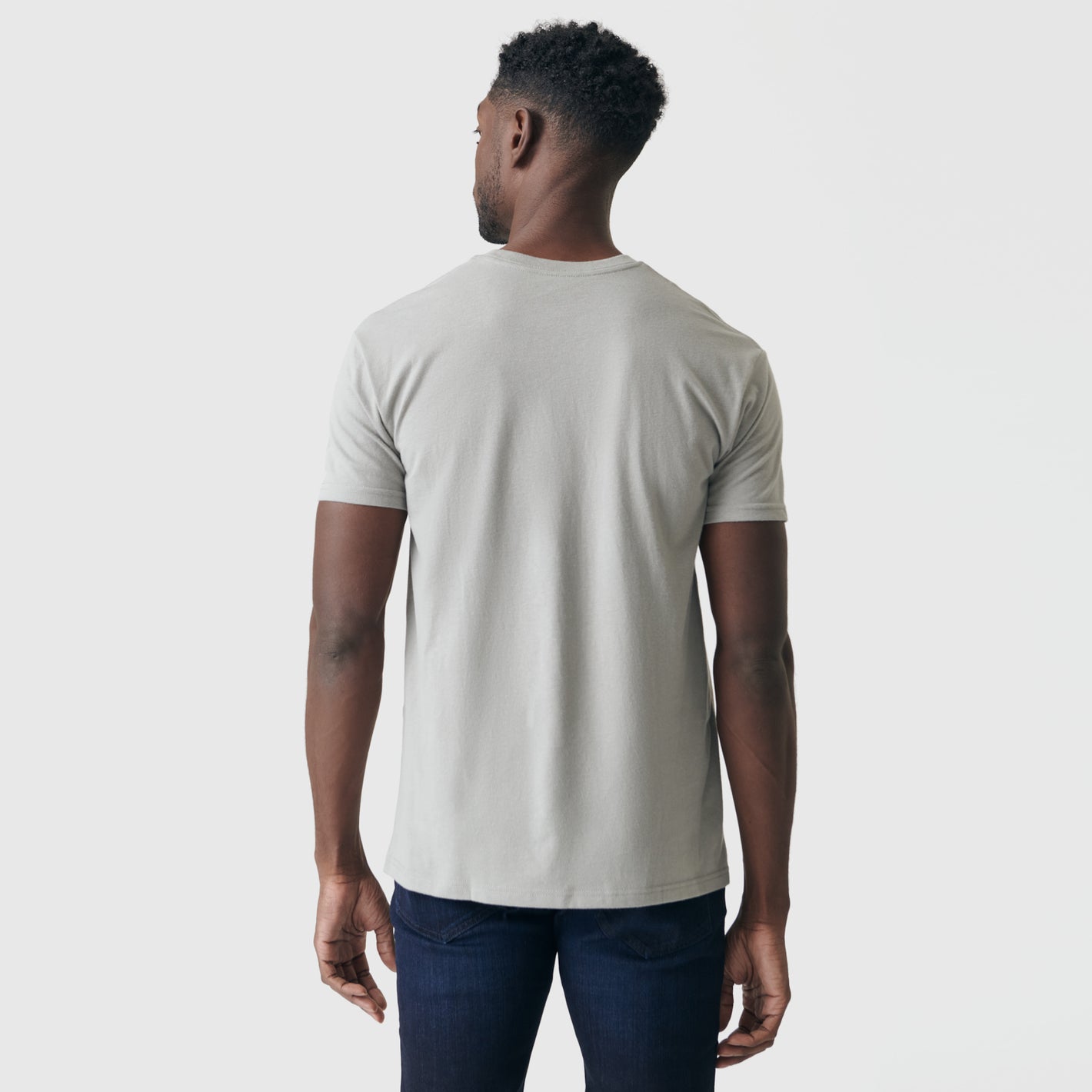 Person wearing Iron Gray Pocket Crew Tee and dark blue jeans.